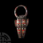 Cameroon Painted Animal Mask. 20th century A.D. A carved wooden animal mask with round-section ring, polychrome geometric detailing; hollow arched rec...