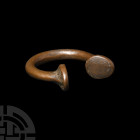 African Slave Trade Bracelet. 18th-19th century A.D. A penannular brass 'manilla currency' bracelet with round-section body and trumpet-style terminal...