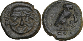 Sicily. Kamarina. AE Tetras, c. 420-410 BC. Obv. Facing gorgoneion. Rev. KAMA. Owl standing right, head facing, grasping lizard; three pellets in exer...
