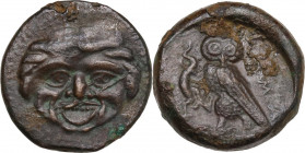 Sicily. Kamarina. AE Tetras, c. 420-405 BC. Obv. Gorgoneion. Rev. KAMA. Owl standing left, head facing, grasping lizard; three pellets in exergue. CNS...