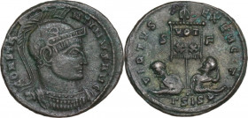 Constantine I (307-337). AE 19 mm, Siscia mint, 320 AD. Obv. Helmeted and cuirassed bust right. Rev. Banner with VOT/XX; on either side, seated captiv...