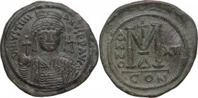 Justinian I (527-565). AE Follis, Constantinople mint, dated RY XII (538-539). Obv. Helmeted and cuirassed bust facing, holding globus cruciger and sh...