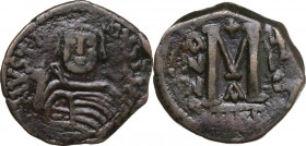 Justinian I (527-565). AE Follis, Nicomedia mint. Obv. DN IVSTINIANVS PF AVG. Helmeted and cuirassed bust facing, holding globus cruciger and shield; ...