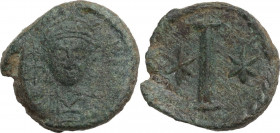Justinian I (527-565). AE 10 Nummi, Rome mint, 547-548. Obv. Helmeted, draped and curiassed bust facing. Rev. Large I flanked by two starts, all withi...