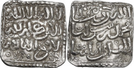 Muwahhiduns (Almohad). Anonymous. AR Dirham, floral type. D/ Kalima and almohad motto in three lines; two floral symbols below. R/ Continuation of alm...