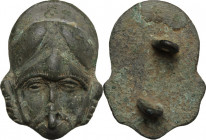 Bronze decorative element in the shape of helmeted head. Late roman period or migration period. 37 x 27 mm.
