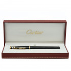 CARTIER Penna roller - TRINITY. Corpo della penna in pregiata resina nera con finiture dorate e 3 anelli al cappuccio di cui uno argentato. Penna in e...