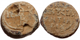Byzantine seal (Lead, 21,0 mm, 12,43 g). Obv: Legend in four lines. 
Rev: Cruciform monogram.
