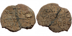 Byzantine seal (Lead, 29,6 mm, 11,74 g). Obv: Legend in four lines. 
Rev: Cruciform invocative monogram, letters in fields.