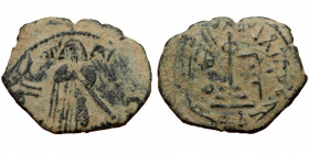 ISLAMIC, Umayyad Caliphate (Arab-Byzantine coinage).end of the C7th and beginning of the 8th century Æ Fals (Bronze, 21mm, 1.74g). 
Obv: Caliph stand...