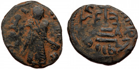 ISLAMIC, Umayyad Caliphate (Arab-Byzantine coinage).end of the C7th and beginning of the 8th century Æ Fals (Bronze, 20mm, 3.12g). 
Obv: Caliph stand...