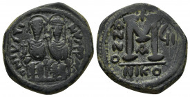 JUSTIN II (565-578 AD). AE, Follis. Nicomedia. RY 6 = 570/571.
Obv: D N IVSTINVS P P AVC. 
Justin II, holding globus cruciger in his right hand, and S...