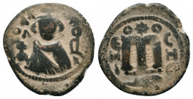 Umayyads, Arab-Byzantine Anonymous . 
Abd al-Malik, 65-86 H./685-705 AD Follis
Obv: Imperial bust facing, to right the mint name in Arabic downwards a...