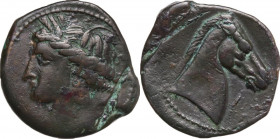 Punic Sardinia. AE 21 mm. c. 300-264 BC. Uncertain mint. Obv. Wreathed head of Kore left, wearing triple-pendant earring. Rev. Horse's head right; bef...
