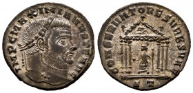 Maximianus. Follis. 307-308 AD. Ticinum. (Ric-VI 92). Anv.: IMP C M A MAXIMIANVS P F AVG, laureate head right. Rev.: CONSERVATORES VRBS VAE, Roma seat...
