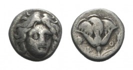 Islands of Caria, Rhodos. Rhodes, c. 305-275 BC. AR Hemidrachm (10mm, 1.50g, 12h). Head of Helios facing slightly r. R/ Rose with bud to r.; to l., gr...