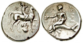 "Calabria, Tarentum. Ca. 281-240 B.C. AR nomos (21.1 mm, 6.51 g, 7 h). Struck 257 B.C. Kynon, magistrate. Nude youth on horseback right, placing wreat...