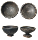 "A pair of Greek black glazed bowls, ca. 4th Century B.C. , the first with pedestal foot, Dia: 3 5/8 in. (9.2 cm, the second with deep bowl and flared...