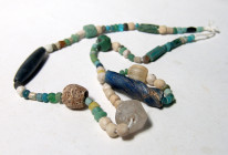 "A strand ancient stone and glass beads. Most of the beads are Roman glass and Romano-Egyptian faience examples, ca. 1st-3rd Century A.D. in cr?me to ...