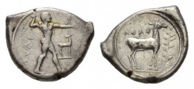 Bruttium, Caulonia Nomos circa 450-445, AR 23mm, 7.88 g. KAVΛ Naked Apollo standing right, holding branch in raised r. hand: on extended l. arm small ...