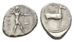 Bruttium, Caulonia Nomos circa 450-445, AR 22mm, 7.97 g. KAVΛ Naked Apollo standing right, holding branch in raised r. hand: on extended l. arm small ...