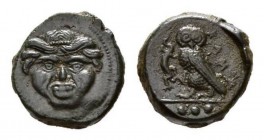 Sicily, Camarina Tetras circa 420-410, Æ 15mm, 3.93 g. Gorgoneion, hair bound with fillet. Rev. KAM Owl standing left on one leg, clutching lizard wit...