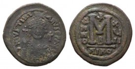 Justinian I 527-565 527-565 Follis 543-544, Æ 36.5mm., 19.98g. D N IVSTINIANVS P P AVG Helmeted and cuirassed bust facing, holding globus cruciger and...