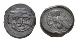 Sicily, Camarina Tetras circa 420-410, Æ 14.5mm., 3.40g. Gorgoneion, hair bound with fillet. Rev. KAM Owl standing l. on one leg, clutching lizard wit...