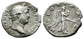 Hadrian, AD 117-138. AR Denarius (16mm, 3.13g). Rome, 134-138. Bare head right / Victory advancing right, pulling out dress and holding branch. RIC II...