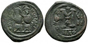 Justin II, AD 565-578. AE Follis (29mm, 13.14g). Struck year 4 (568/569 AD). Nicomedia mint. D N IVSTI NVS P P AVI, Justin, on left, holding globus cr...
