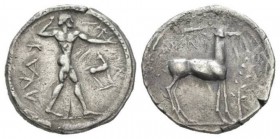 Bruttium, Caulonia Nomos 475-425, AR 21.5mm., 7.78g. Apollo walking r., holding laurel branch and small running daimon; in field r., stag r. Rev. Stag...