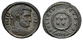 Licinius, 308-324 Follis Siscia 320 - 321, Æ 20.5mm., 3.07g. IMP LICINIVS AVG Laureate bust r. Rev. D N LICINI AVGVSTI in centre VOT/XX within wreath;...