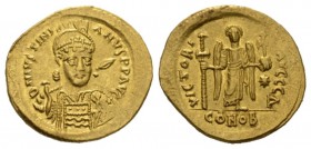 Justinian I, 527-565. Solidus 527-537, AV 21.5mm., 4.32g. D N IVSTINIANVS P P AVC Helmeted and cuirassed bust facing; holding spear and shield. Rev. V...