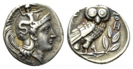 Calabria, Tarentum Drachm circa 302-280, AR 15.5mm., 3.18g. Head of Athena r., wearing crested Attic helmet ornamented with Skylla hurling a stone. Re...