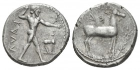 Bruttium, Caulonia Nomos circa 475-425, AR 21.5mm., 8.12g. Apollo advancing r., holding branch in right hand and small daimon running r. on extended l...