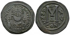 Justinian, 527 – 565 Follis 541-542 (year 15), Æ 30.5mm., 22.73g. Helmeted, pearl-diademed and cuirassed bust facing, holding globus cruciger and shie...