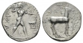 Lucania, Caulonia Nomos circa 475-425, AR 21mm., 8.03g. KAVΛ Naked Apollo standing r., holding branch in raised r. hand: on extended l. arm small runn...