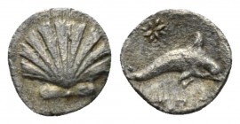 Calabria, Tarentum Hemilitron circa 325-280, AR 9.5mm., 0.60g. Cockle shell. Rev. Dolphin r.; abive star and below, uncertain symbol or monogram below...