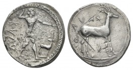 Bruttium, Caulonia Nomos circa 475-425, AR 21.5mm., 7.88g. Apollo standing r., holding branch in r. hand, small daimon running r. on extended l. arm; ...