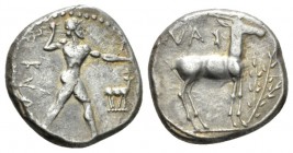 Bruttium, Caulonia Nomos circa 475-425, AR 21.5mm., 7.74g. Apollo advancing r., holding branch; small daimon running right on Apollo's left arm; in fr...