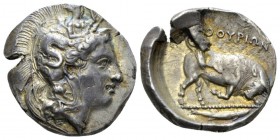 Lucania, Thurium Dinomos circa 400-350, AR 28mm., 15.46g. Head of Athena r., wearing crested Attic helmet decorated with Scylla hurling stone. Rev. Bu...