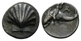 Calabria, Tarentum Litra circa 325-280, AR 9.5mm., 0.69g. Cockle shell. Rev. Dolphin rider l. Vlasto 1599-1605. Historia Numorum Italy 980 Dark patina...