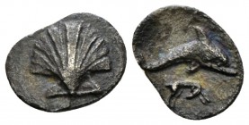 Calabria, Tarentum Litra circa 325-280, AR 11mm., 0.58g. Scallop shell. Rev. Dolphin r.; hound below. Vlasto 1494; Historia Numorum Italy 979. Very ra...