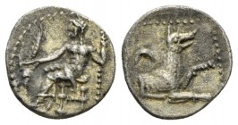 Lycaonia, Laranda Obol circa 324-323, AR 10.5mm., 0.64g. Baaltars seated l., holding grain ear, grape bunch, and sceptre. Rev. Forepart of wolf r.; in...