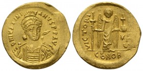 Justinian I, 527-565. Solidus Constantinople circa 527-565, AV 19.5mm., 4.19g. Helmeted and cuirassed bust facing r., holding spear and shield. Rev. V...