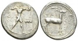 Bruttium, Caulonia Nomos circa 475-425, AR 21.5mm., 7.92g. Apollo walking right, holding laurel branch and small running daimon; in field r., stag r. ...