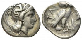 Calabria, Tarentum Drachm circa 302-280, AR 16mm., 3.18g. Head of Athena r., wearing Attic helmet decorated with Skylla. Rev. Owl r., wings closed, st...
