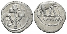 Iulius Caesar. Denarius mint moving with Caesar 49-48, AR 19mm., 4.03g. Pontifical emblems: culullus, aspergillum, axe and apex. Rev. Elephant r., tra...