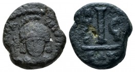 Maurice Tiberius, 582-602. Decanummo Catania 587-588 (year 6), Æ 12.5mm., 2.80g. Helmeted and cuirassed facing bust, holding globus cruciger. Rev Larg...