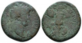 Judaea, Caesarea Maritima Titus Caesar, 69-79 Bronze circa 69-79, Æ 24mm., 12.49g. Laureate head r. Rev. Trophy; bound captive seated to l., to r. shi...